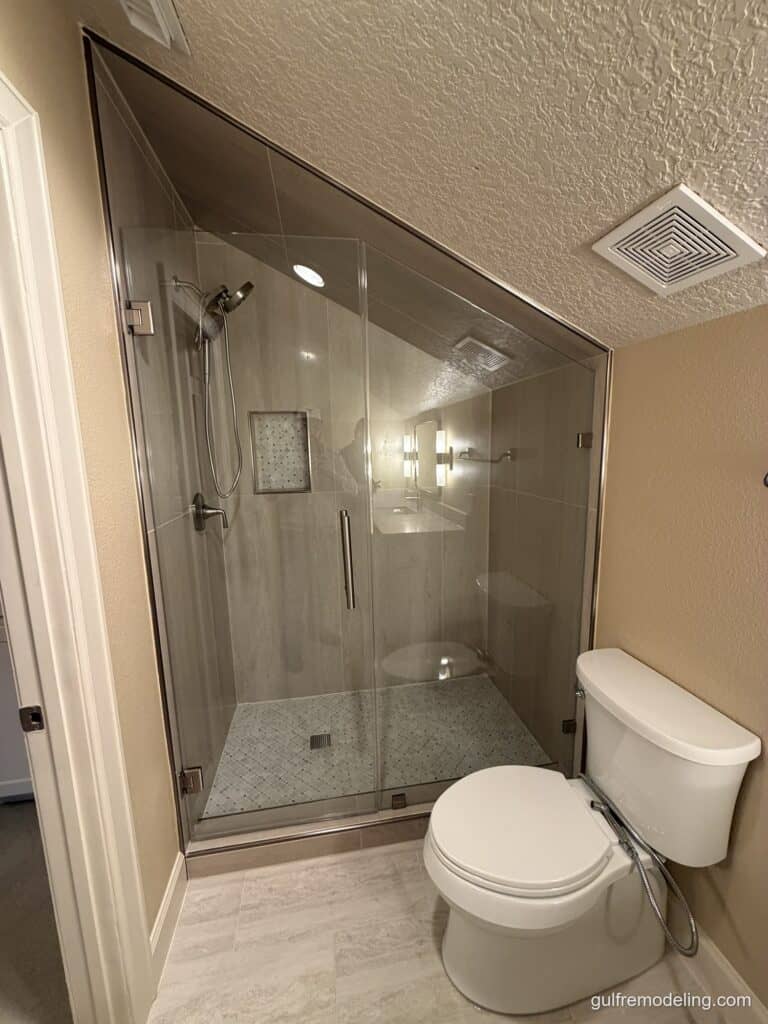 Glass shower built under a sloped ceiling - bathroom remodel in Houston