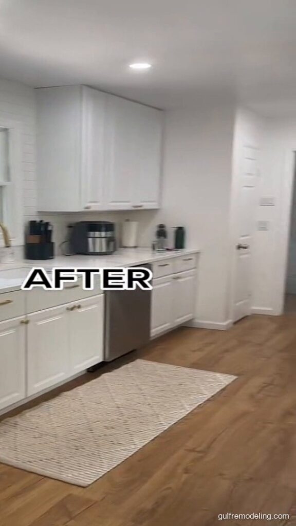 Same kitchen after the remodel: white cabinets and wood-look floor - Houston