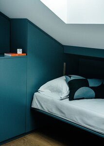 Cozy modern bedroom corner with minimalist design and warm light.