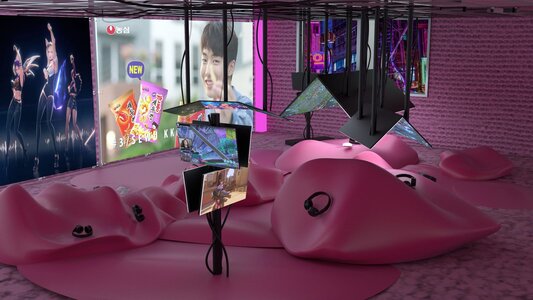 Vibrant pink immersive installation blends digital media and soft shapes for an engaging experience.