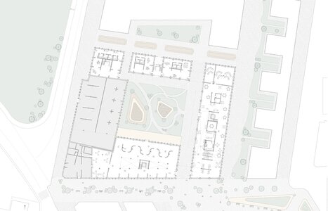 Urban architectural site plan featuring a central green courtyard and mixed-use buildings.