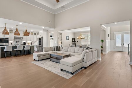 Spacious living room with neutral tones, large sectional sofa, and natural light.