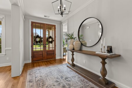 Doorway with beautiful wood double doors and a wreath for a welcoming entrance.