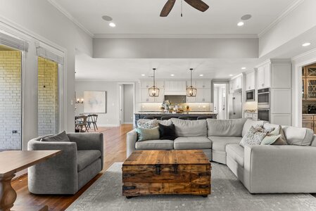 Bright spacious living room with cozy sofas and wooden coffee table.