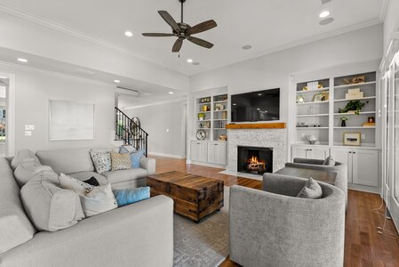 Bright living room with elegant fireplace, custom shelving, and modern decor for a stylish home interior.
