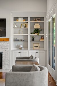 Bright living room bookshelf with modern decor and lighting.
