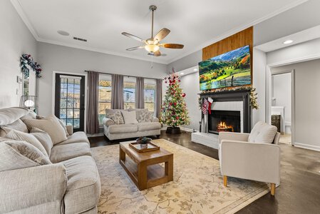 Bright living room with holiday decorations and fireplace for family gatherings.