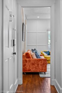 Bright, inviting living space with vibrant sofa and decorative pillows.