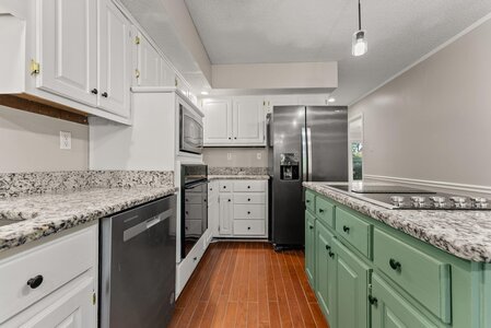 Bright modern kitchen with granite countertops and stainless steel appliances.