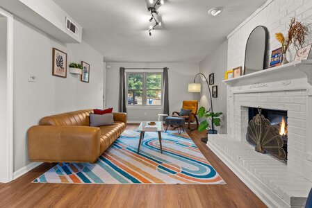Bright living room featuring fireplace, contemporary furniture, and natural light.