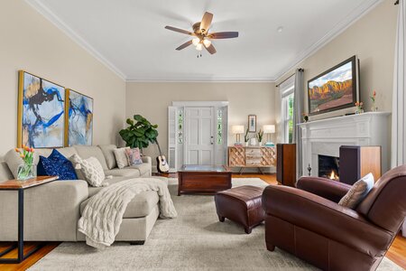 Spacious living room featuring a fireplace, comfortable seating, and natural light.