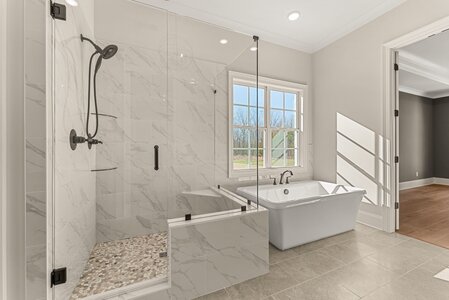 Bright modern bathroom featuring a walk-in shower and freestanding soaking tub.
