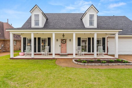 Delightful house exterior featuring a porch and landscaping, perfect for homebuyers and real estate listings.