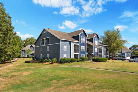 Stylish multi-unit apartment complex with well-maintained landscaping and ample parking options.