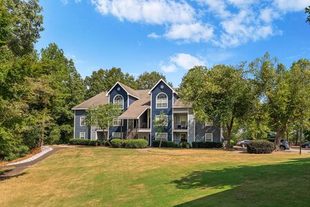 Multiple parking spaces and well-maintained landscape at a scenic residential community.