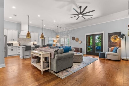 Spacious living room with cozy seating, hardwood floors, and stylish decor.