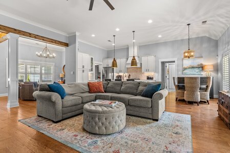 Bright, spacious living room with comfortable seating, wooden accents, and contemporary style.