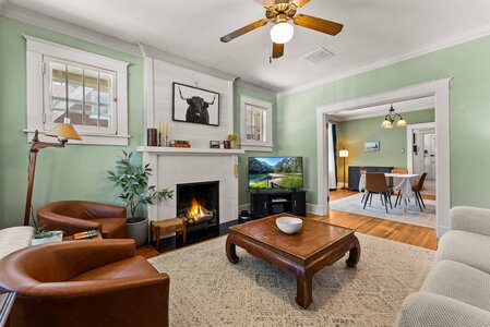 Elegant living space with fireplace, stylish furniture, and natural light for cozy home ambiance.