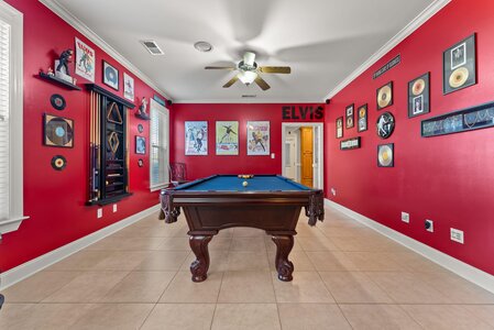 Vintage Elvis Presley collectibles and decor with pool table in entertainment room.