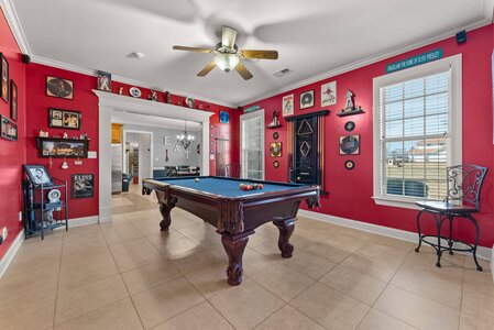 Elvis Presley memorabilia in game room with pool table and Elvis themed decor.