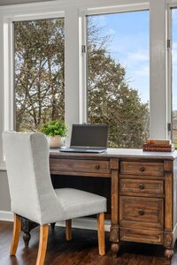 Versatile workspace with classic decor, blush light filling the room, ideal for productivity and relaxation.