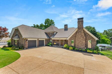 Elegant brick home with manicured garden and double garage, perfect for luxury living.