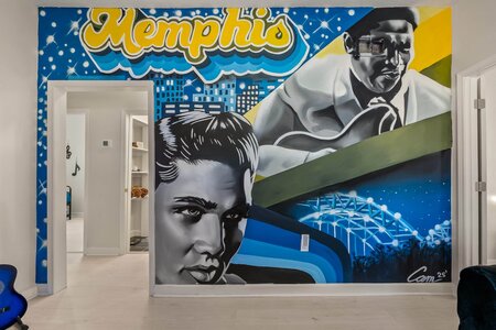 Vibrant Memphis-themed mural with portraits, cityscape, and musical elements.