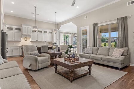 Bright, inviting living space with cozy seating and large windows.
