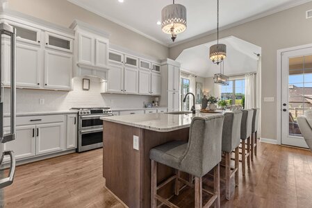 Beautiful kitchen with white cabinets, granite countertops, and spacious dining area.