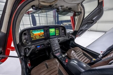 Detailed helicopter cockpit interior with flight instruments and navigation displays.