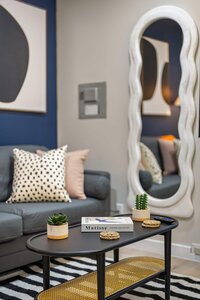 Elegant living space with contemporary decor and decorative pillows.