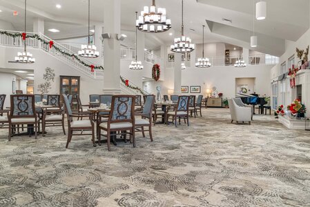 Christmas-themed hotel lobby with festive garlands, holiday decorations, and comfortable seating areas for guests.
