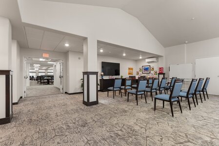 Spacious conference room with chairs and presentation area, perfect for meetings and events.