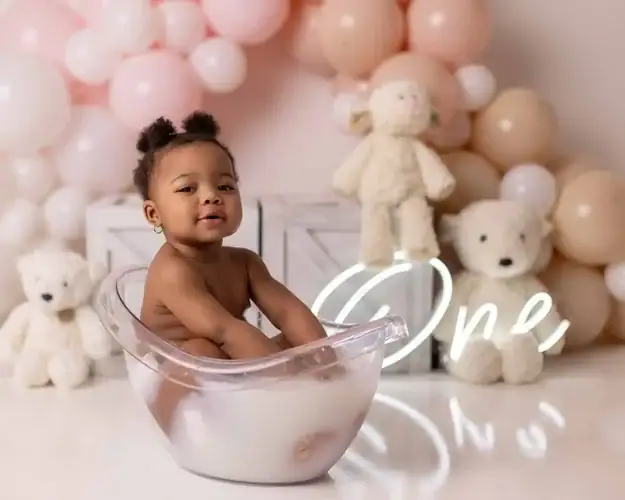 baby girl taking her milk bath photo while her first birthday photoshoot in Edmonton