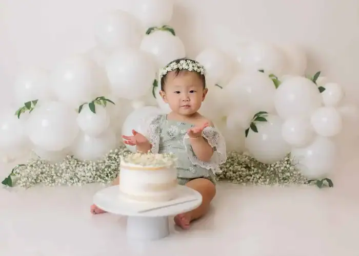 Minimalist cake smash theme with white balloons, simple decor, and a clean background for an Edmonton girl