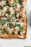 A thin crust Caramelized Onion, Mushroom, and Spinach Pizza perfect for those weeknights when you want a quick fix dinner!