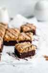 Samoas brownies AKA fudgy brownies topped with homemade coconut caramel sauce and drizzled with chocolate. Perfect for any Girl Scout cookie lover!