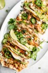 Loaded BBQ Chicken Street Corn Tacos made with fresh corn, crema, avocado, tender chicken, and cotija cheese. What more could you ask for?