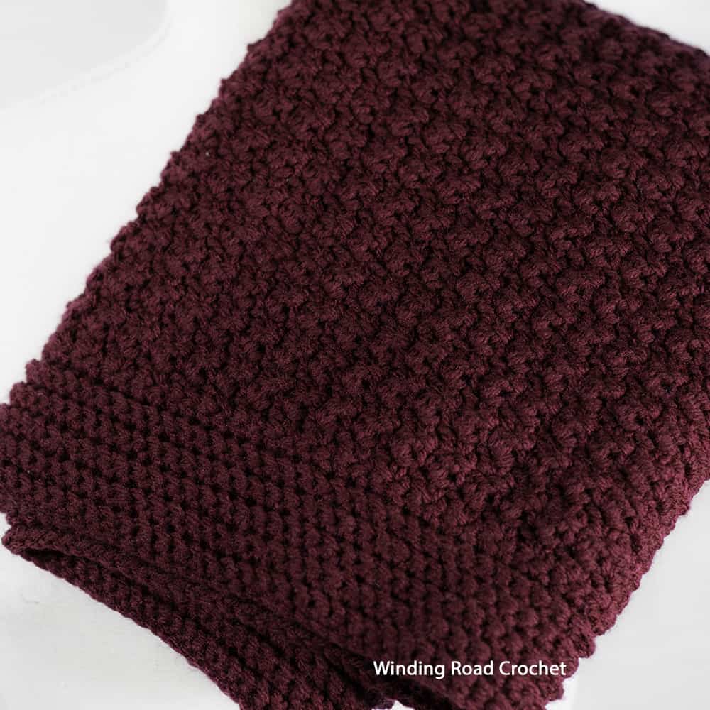 This textured crochet cowl is large looks like an infinity scarf and tall enough to be a hood. Enjoy the free crochet pattern and video.