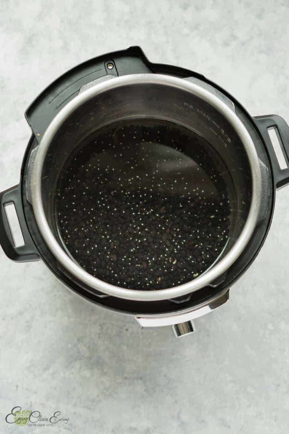the instant pot is ready with dry beans and water to start pressure cooking.
