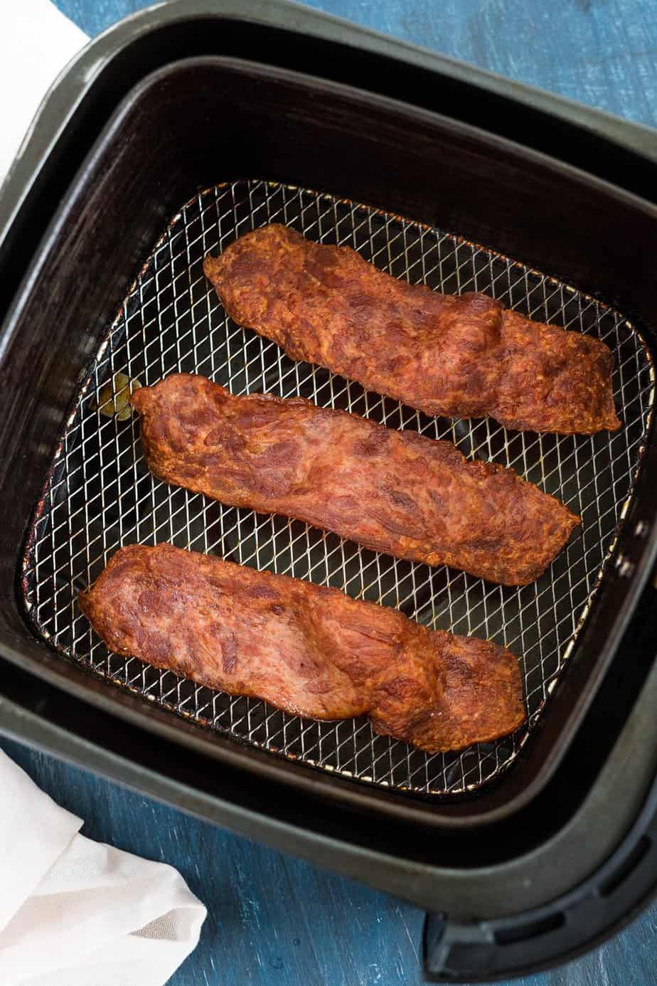 Turkey bacon cooked inside the air fryer basket