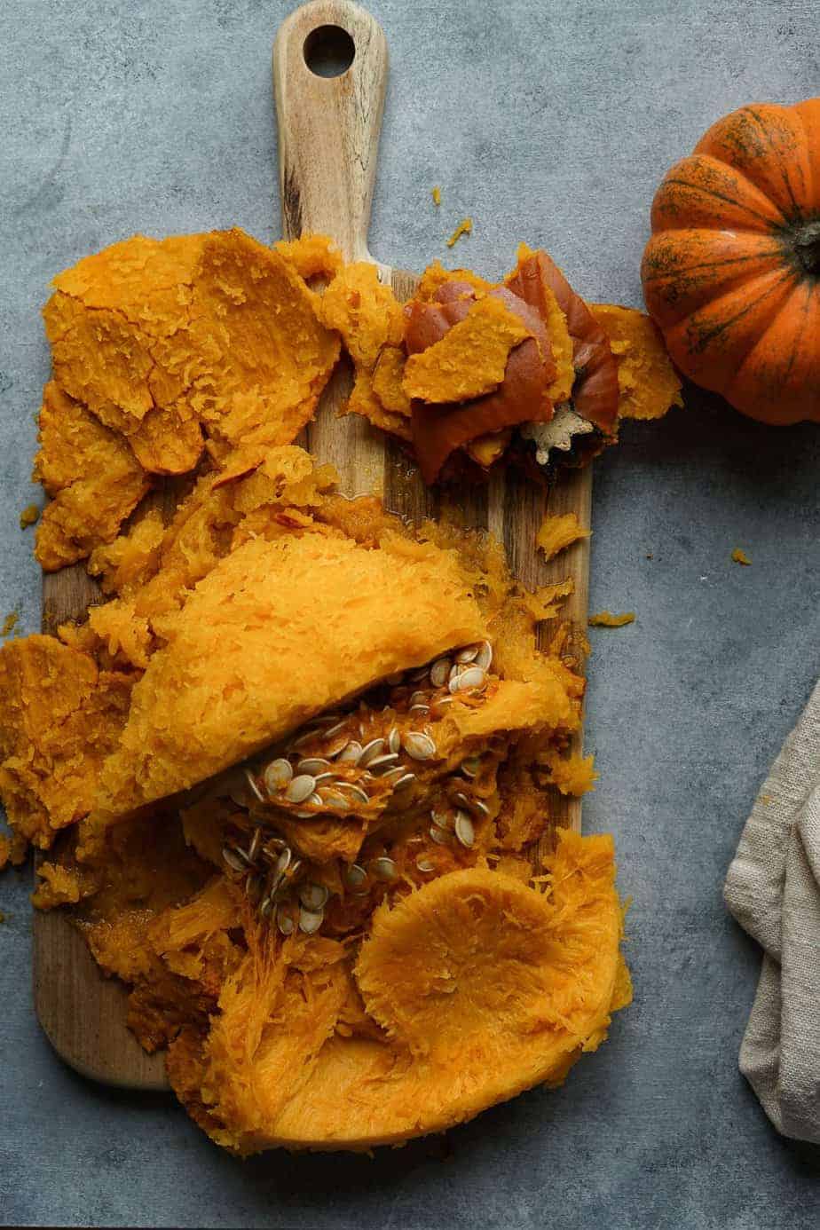 Once the skin is removed cut the pumpkin in the cutting board and start to remove the seeds