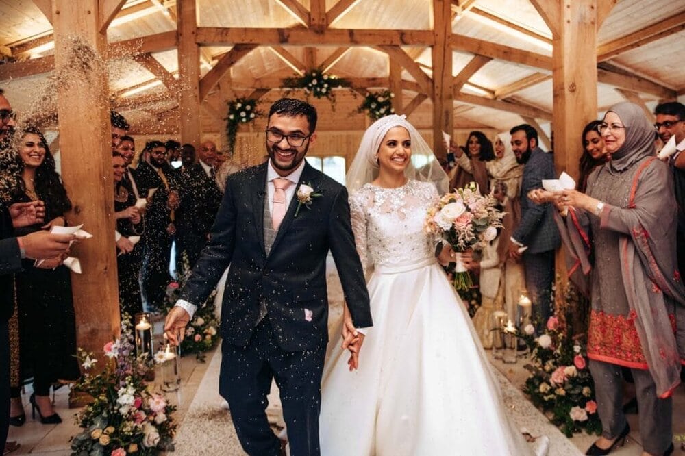 Colshaw Hall Bride and Groom walking down the aisle to confetti