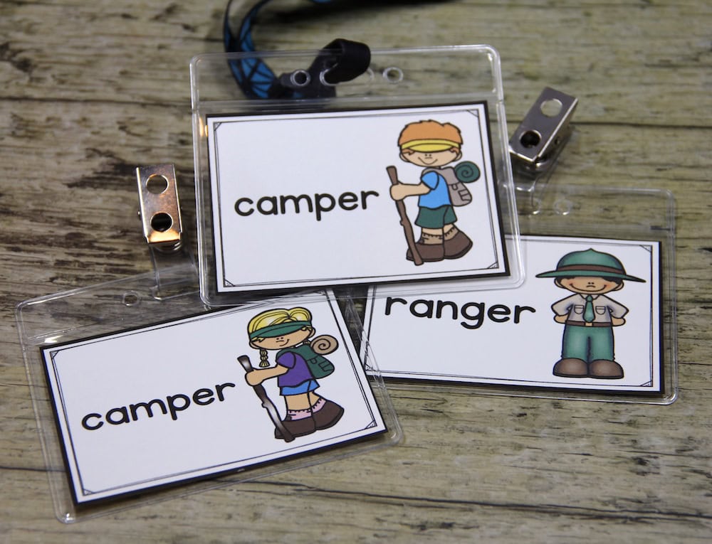 Photo of student role play badges for a camping center: some say "camper" and one says "ranger"