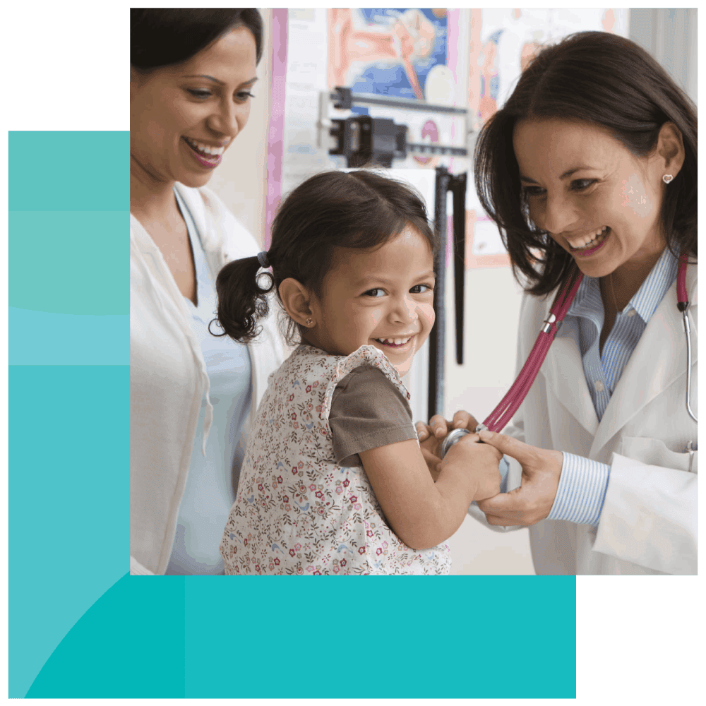 Pediatrician lets a young girl play with her stethoscope Everyone smiles as a pediatrician lets a young girl play with her stethoscope