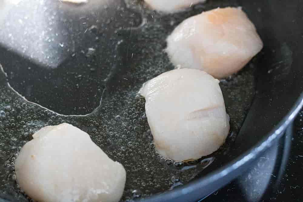 Step Two Of Cooking Scallops - Placing in a hot pan | AmateurChef.co.uk