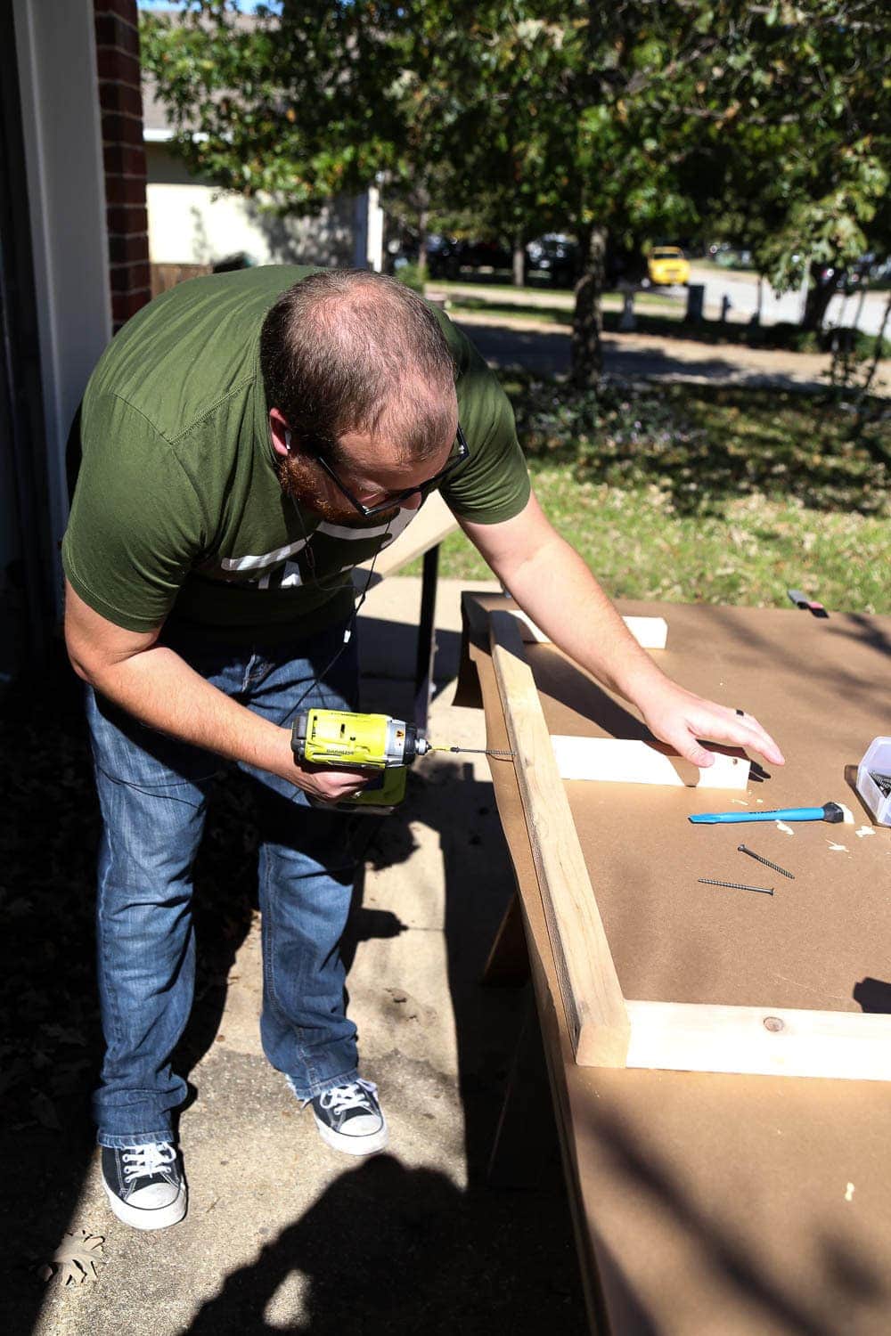 man constructing support boards for floating shelves