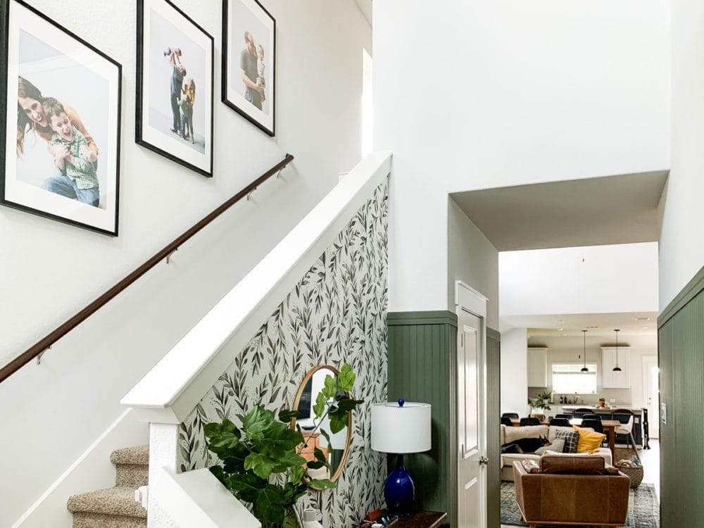 entryway with family photos going up stairs