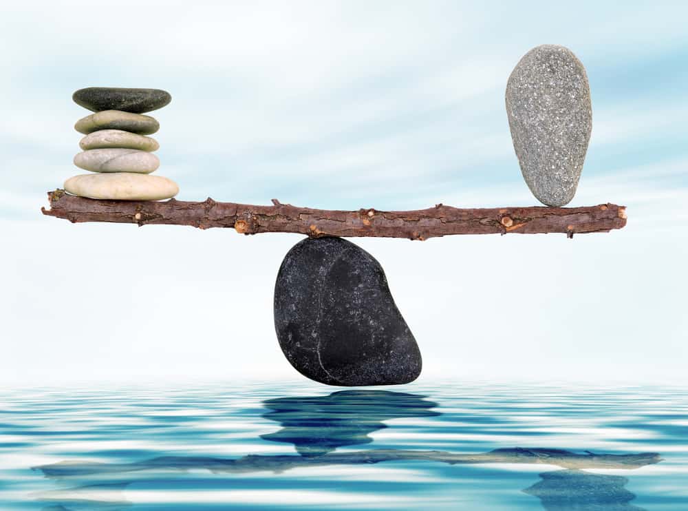 shutterstock_111521852 (2) picture depicting a fulcrum with stones balanced on it to illustrate life balance
