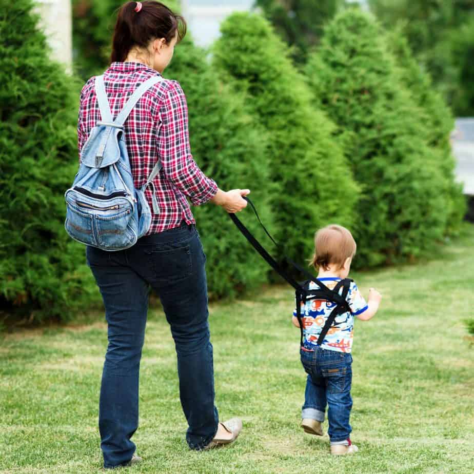 A young mom is walking with her child at the park